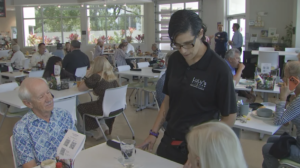 Waitress taking an order from a couple seated at LuLu's Kitchen.