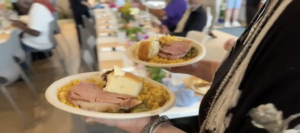 A volunteer serving Easter meals at LuLu's Kitchen
